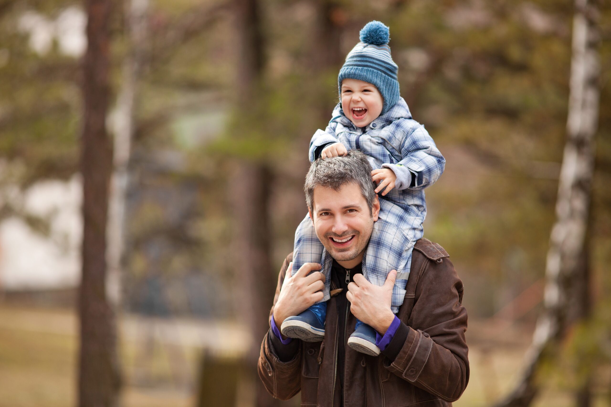 man met jong kind op de schouders