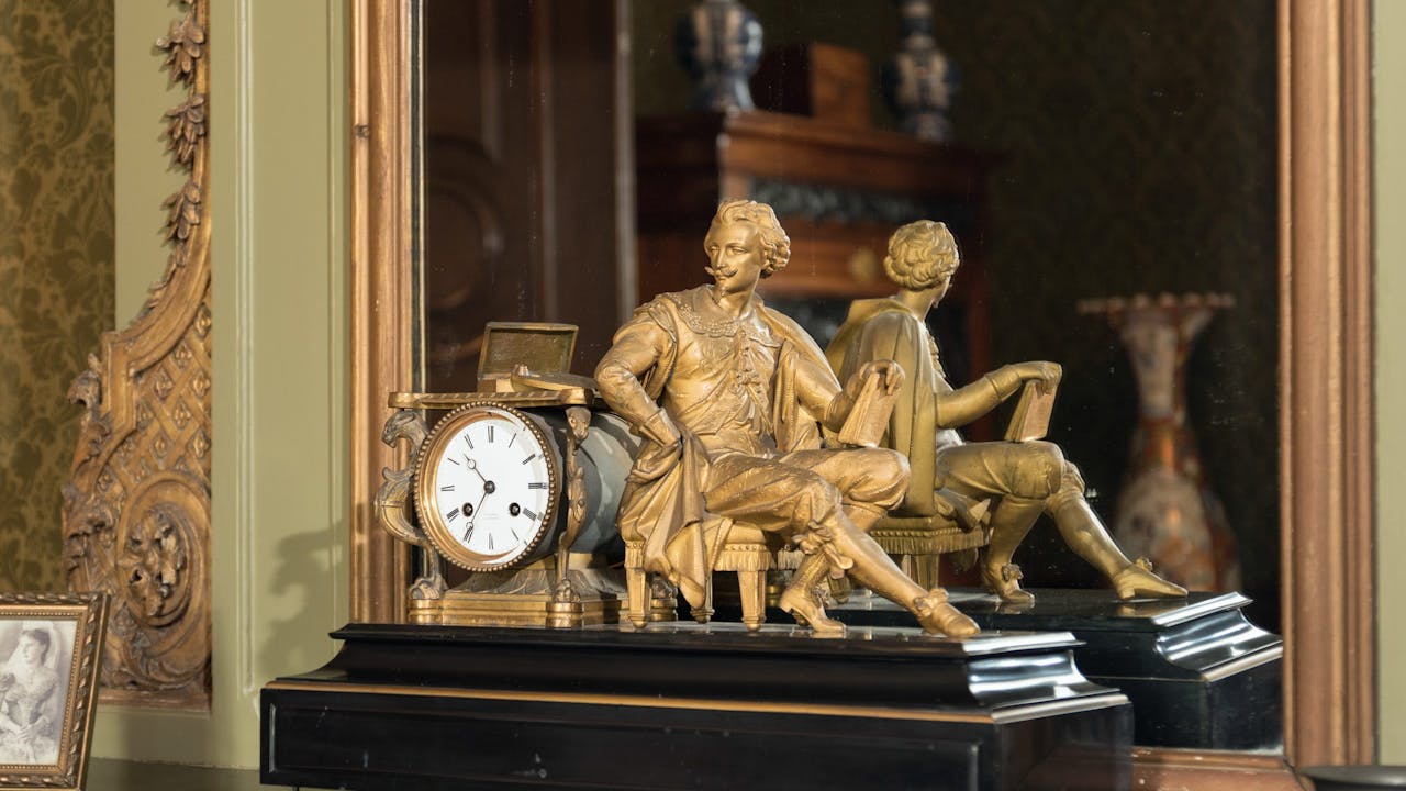 Klok staande op schouw van de derde salon